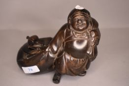 An antique bronze Japanese censor or incense burner in the form of a merchant