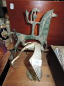 Two ethnic styled metal studies, including brass stork or wading bird.