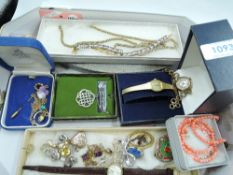 A selection of costume jewellery including Edwardian style rolled gold pendant, brooches, wrist