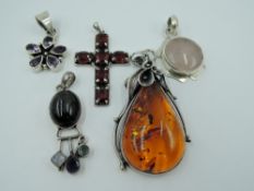 Five HM silver and white metal pendants stamped 925 including large Baltic Amber, pink agate, red