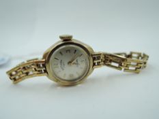 A lady's 9ct gold wrist watch by Rotary having a baton & Arabic numeral dial to small face in 9ct
