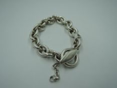 A silver link bracelet of chunky form by Georg Jensen having bar and loop clasp and later fitted