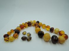 A knotted string of multi coloured Baltic amber beads with two pairs of matched stud earrings, all