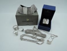 Three pieces of Swarovski crystal jewellery including Swan pendant, crystal bracelet and ring, two