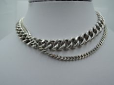 A silver curb chain of heavy form, approx 24' & 66.2g and a silver flat link curb chain, approx