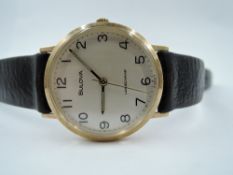 A gent's 9ct gold Bulova Longchamp manual wrist watch having Arabic numeral dial to circular face in