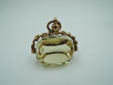 A cut citrine fob in a 9ct rose gold swivel mount, approx 8.5g