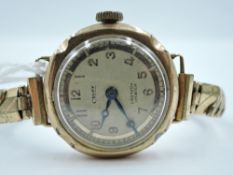 A lady's vintage 9ct gold wrist watch by CROFF having Arabic numeral dial to silvered face in shaped