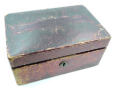A vintage jewellery box containing a small selection of jewellery including yellow wire and bead
