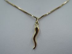 A yellow metal 'horn of plenty' charm on a 9ct gold box chain, approx 18' & 4.4g