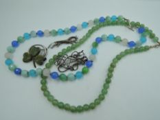 Four HM silver brooches including Scottish & Irish and two strings of beads including jadeite style