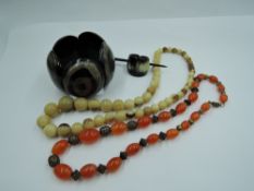 Three pieces of horn jewellery including string of beads, oversized panelled bracelet, hair clip,
