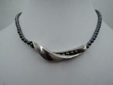A hematite bead necklace by Georg Jensen having a central silver slide twist panel, approx 35g