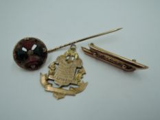 Three pieces of rose gold jewellery, hallmarked and stamped 9ct including presentation medalion, bar