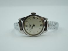 A lady's Longines manual wrist watch having Arabic and baton numeral dial to silvered face in