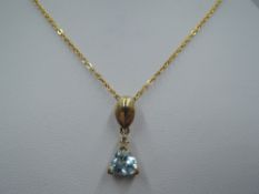 A 9ct gold pendant having cubic zirconia and turquoise paste stone on a 9ct gold chain, approx 2.7g