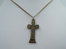 A yellow metal cross pendant stamped 9ct having Celtic style decoration to front, (possibly modelled