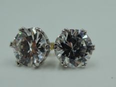 A pair of 9ct gold stud earrings having crystal solitaires in claw set mounts