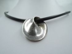 A silver Mobius pendant no 374 by Georg Jensen having a fluid shaped silver disc pendant stamped
