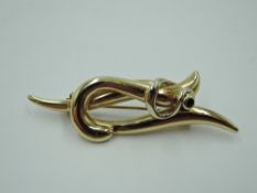 A 14ct gold brooch of stylised form having inset sapphire, approx 4.9g