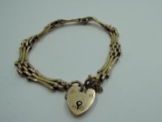 A yellow metal decorative gate bracelet stamped 9C having padlock clasp, approx 5.6g