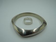 A silver bangle of angled heavy form and a matched ring also stamped 925, approx 76.1g