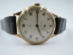 A gent's vintage 9ct gold Tudor wrist watch having Arabic numeral dial with subsidiary seconds to