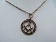 A 9ct gold pendant bearing the Freemason's emblem on a yellow metal chain stamped 9C, approx 19' &