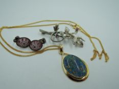 A faux black opal pendant having a gold plated mount stamped SIL/925 on a gold plated chain, a