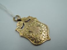 A Victorian 9ct rose gold medalion of shield form bearing small engraving of Robbie Burns to