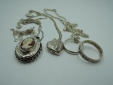 A small selection of HM silver and white metal jewellery including two lockets, chains and band