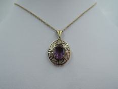 A 9ct gold pendant having an amethyst style stone in a decorative mount on a 9ct gold chain,