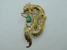 A yellow metal Oriental brooch stamped 14K in the form of a Chinese Dragon, approx 3.1g