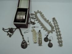 A small selection of white metal jewellery including dolphin pendant stamped 925, Mexican plaque