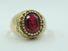 A yellow metal signet ring stamped 750 having an inset oval ruby, size I/J & approx 3.7g