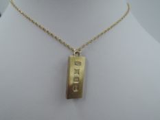A gold plated silver ingot pendant with St Christopher to reverse on a 9ct gold chain, approx