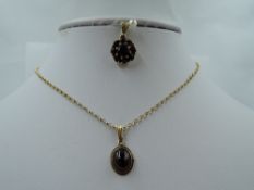 A small garnet cabouchon pendant in 9ct gold mount on a 9ct gold belcher chain, approx 15' & 3g