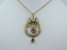 A yellow metal Edwardian pendant of circular form stamped 9ct having bow detail with seed pearl