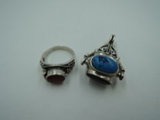 An HM silver spin fob having four oval non precious stone panels, and a silver Artisan style dress