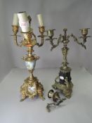 A Victorian brass and black slate candle garniture and similar having hand painted panels.