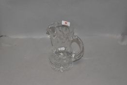 A water jug or decanter by Edinburgh crystal in a Scotch thistle design