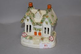 A Staffordshire pottery pastel burner in the form of a house or cottage