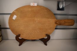 A carved oak bread or cheese board, from the workshop of Robert 'Mouseman' Thompson