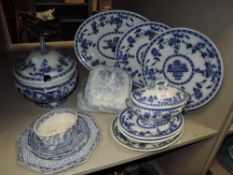 A mixed lot of blue and white ware including tureens, platters and more.