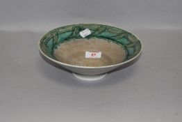 An arts and crafts style bowl by Royal Lancastrian pottery having green glaze marked ETR to base