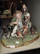 A capodimonte figure depicting a tramp with three dogs also included are four days gone vehicles.