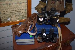 Two pairs of binoculars, possibly military and a three draw telescope.