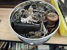 A tin full of keys for a variety of mechanisms.