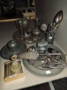 A selection of flatware, two candle sticks and an ink well.