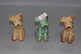 A set of three Sylvac dog figures in brown and green glazes